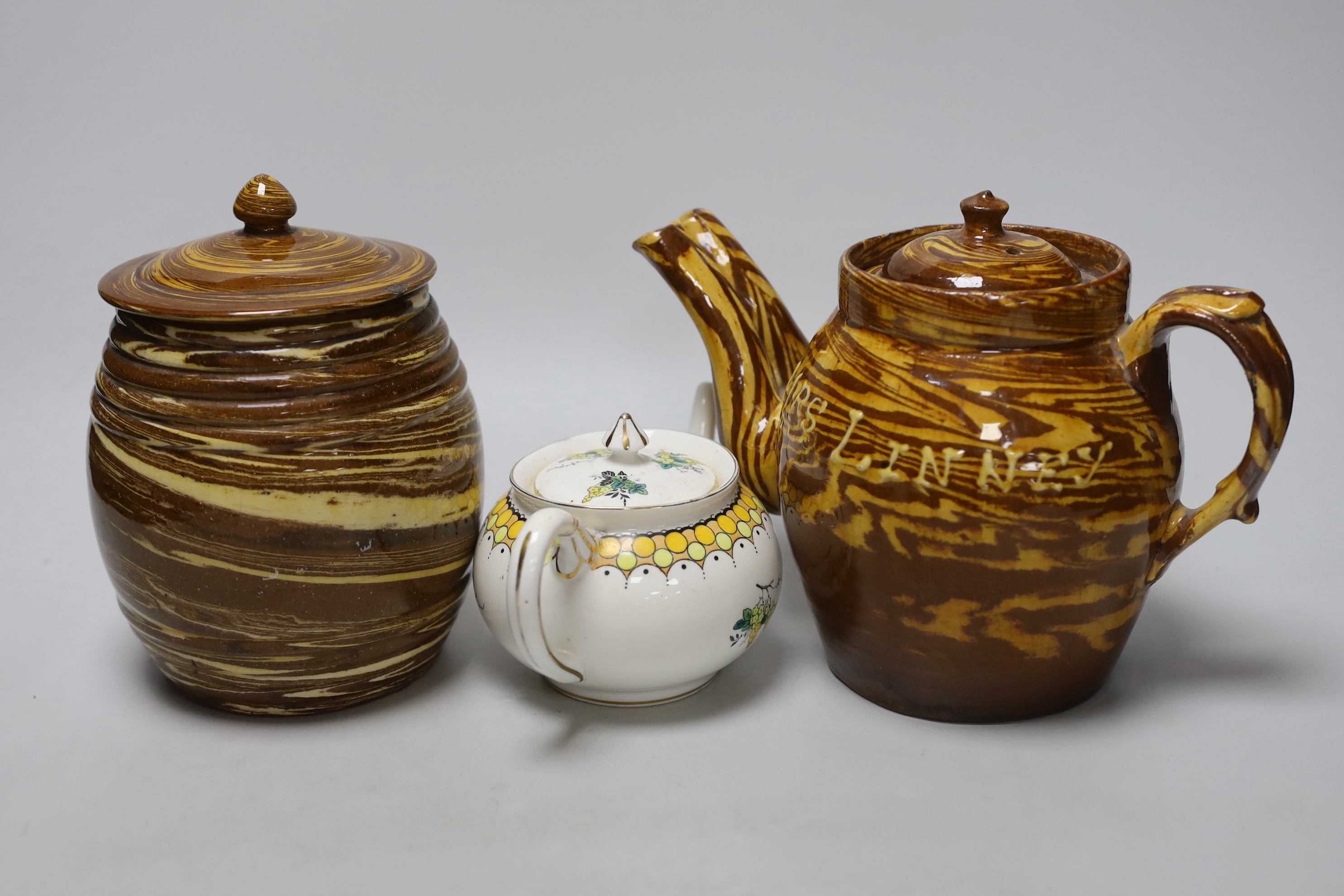 A late 19th century Scottish agate ware teapot and a sugar barrel and a Harrods Stella teapot, lidded pottery sugar jar dated 1888, the largest 20cm high